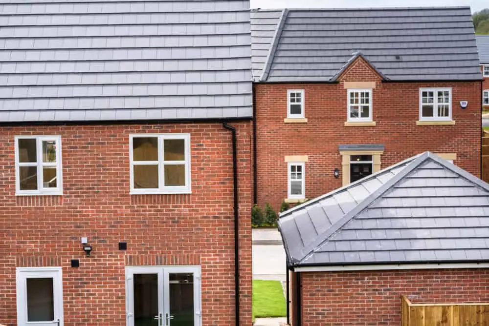 Modern UK brick-built houses, the type of residential property that may need unoccupied property insurance when left empty.