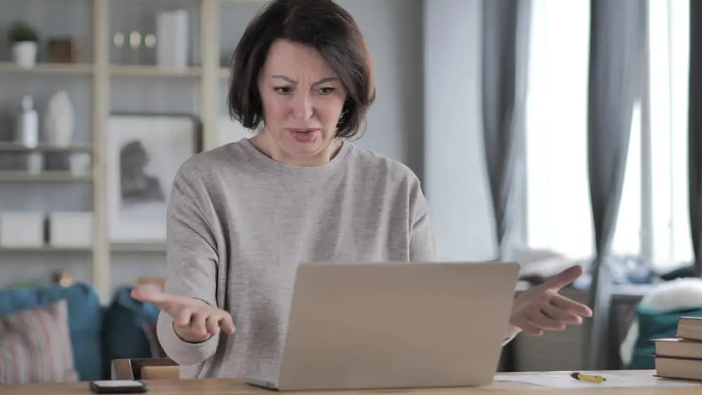 Frustrated woman trying to compare unoccupied home insurance